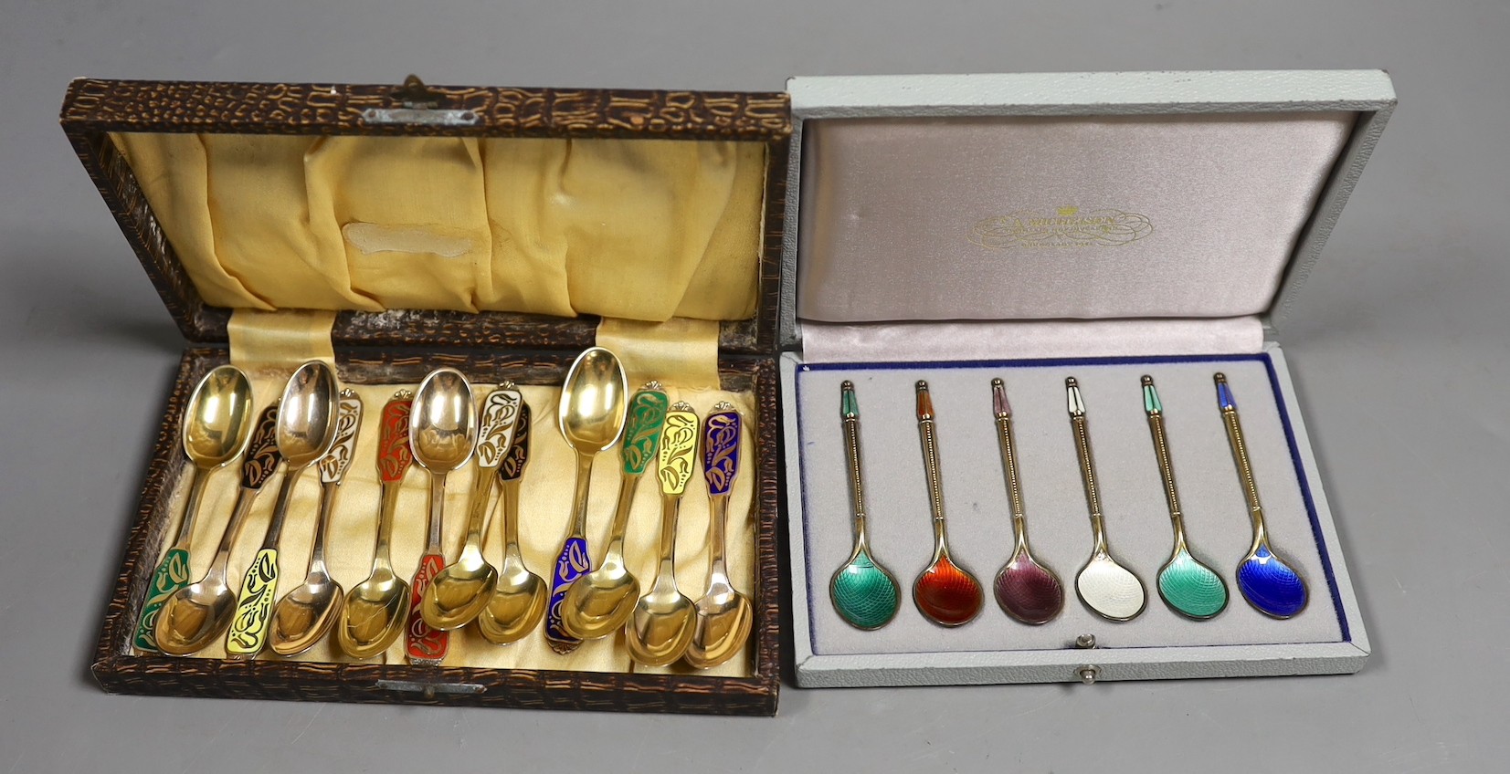 A set of of twelve Danish sterling and polychrome enamel coffee spoons, by W & S Sorenson, 94mm and a similar cased set of six coffee spoons by A. Michelsen.